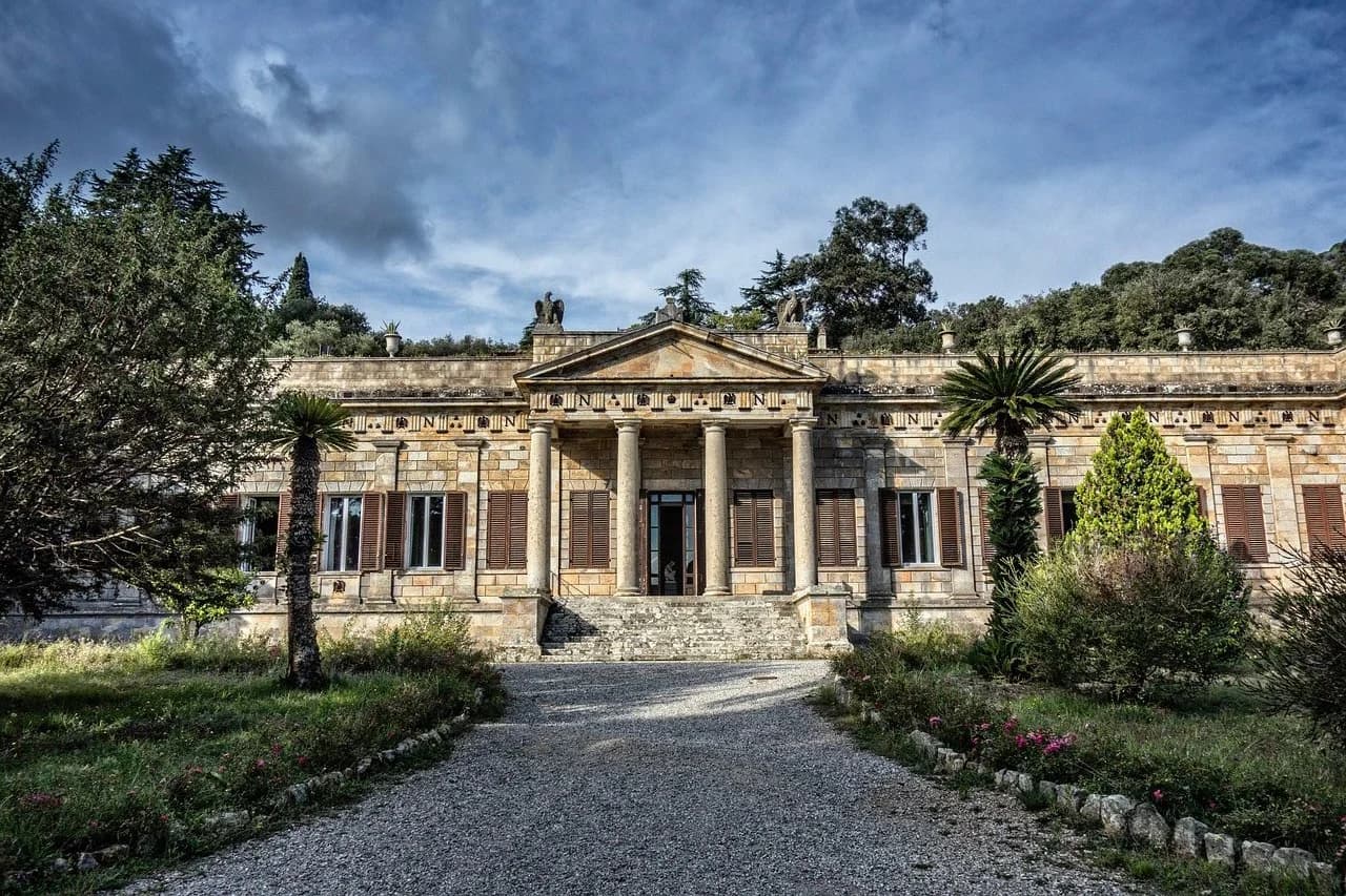 The neoclassical Villa di San Martino, one of Napoleon's residences on Elba, stands elegantly with its pillared facade and surrounding greenery.