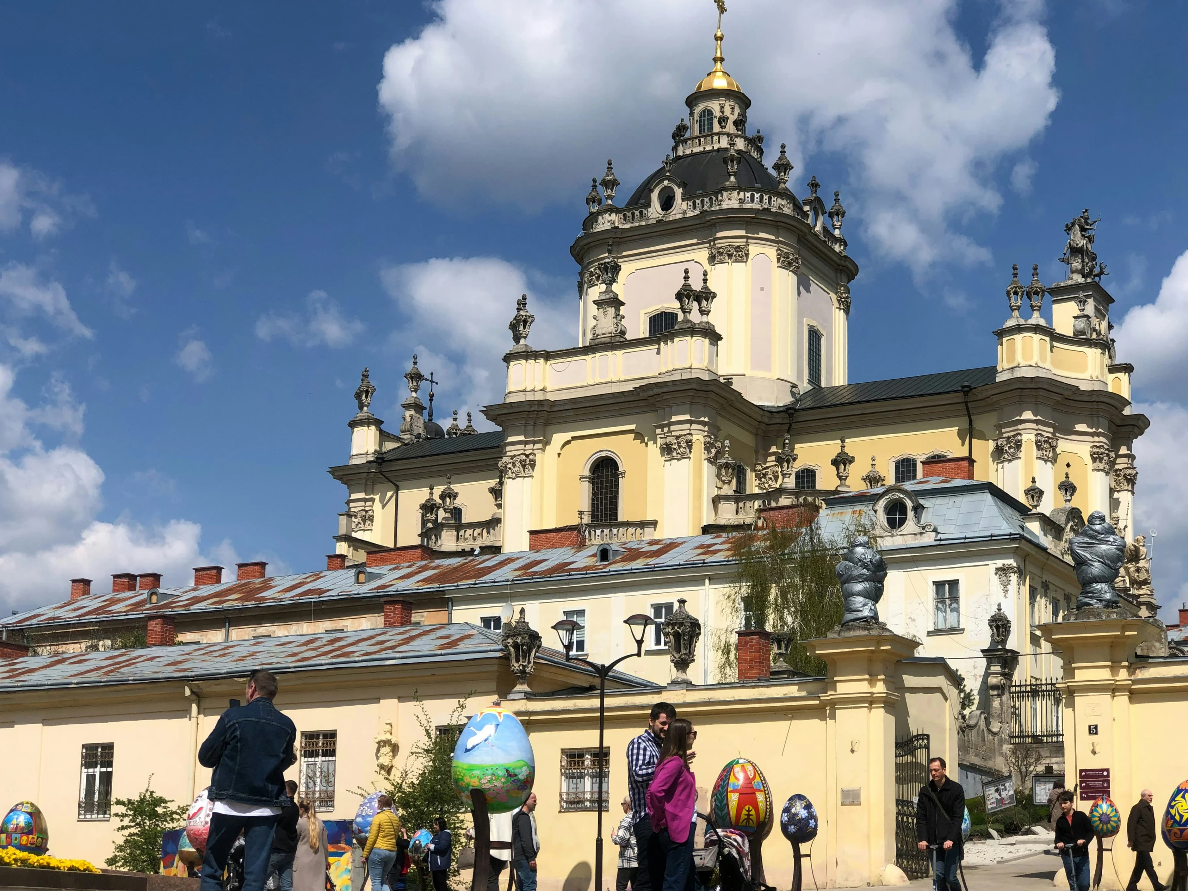 A close-up view of the Church of St. Michael in Lviv, with a crowd of people in front.