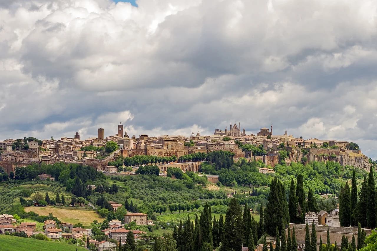 The dramatic city of Orvieto is perched on a volcanic rock, with its historic buildings and medieval towers overlooking the Umbrian valley.