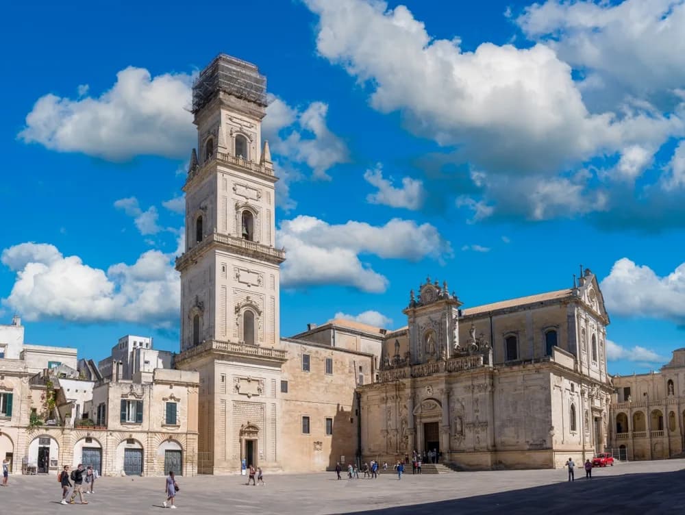 Sunny day in Piazza del Duomo in Lecce, Italy, showcasing the grandeur of the Cathedral's bell tower and Baroque architecture