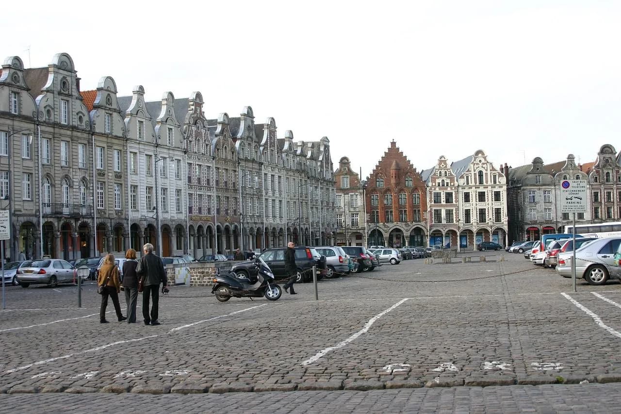 The Grand'Place of Arras is a bustling square surrounded by beautiful Baroque buildings with unique gabled facades.
