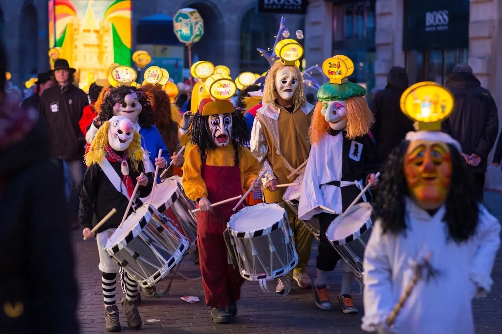 The lively Basler Fasnacht, a three-day carnival, fills the streets of Basel with people in colorful masks and costumes playing drums.