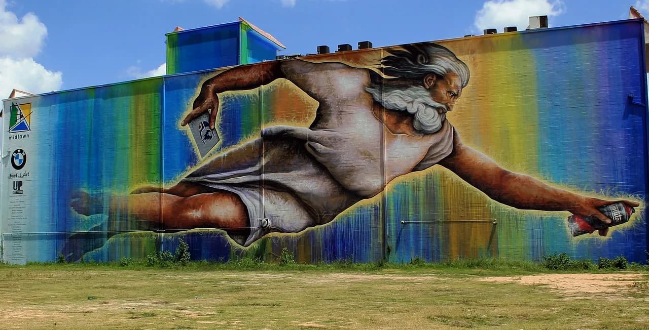 A large, colorful mural of a flying figure with a beard and a red can adorns the side of a building, a testament to the city's vibrant street art.