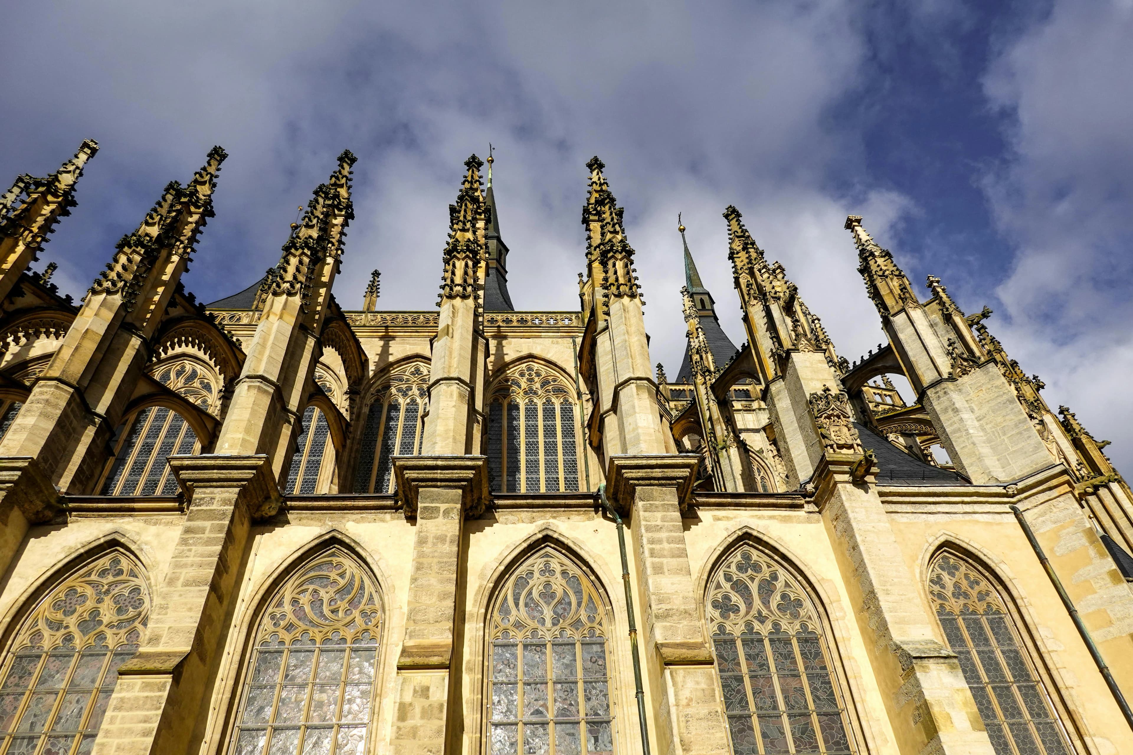 A low-angle view captures the stunning, soaring spires and ornate details of St. Barbara's Cathedral.