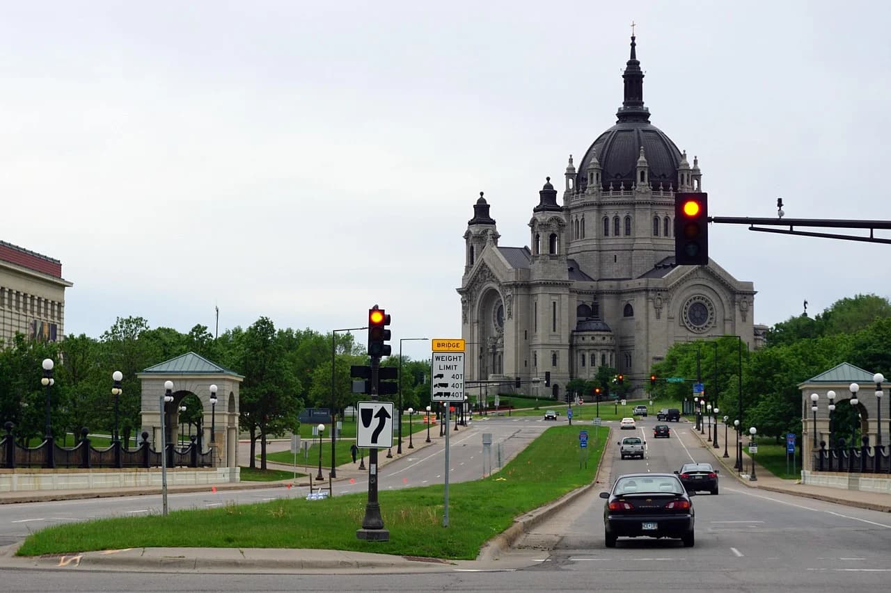 The magnificent Basilica of Saint Mary, with its large dome and classical architecture, is a prominent landmark on a busy city street.