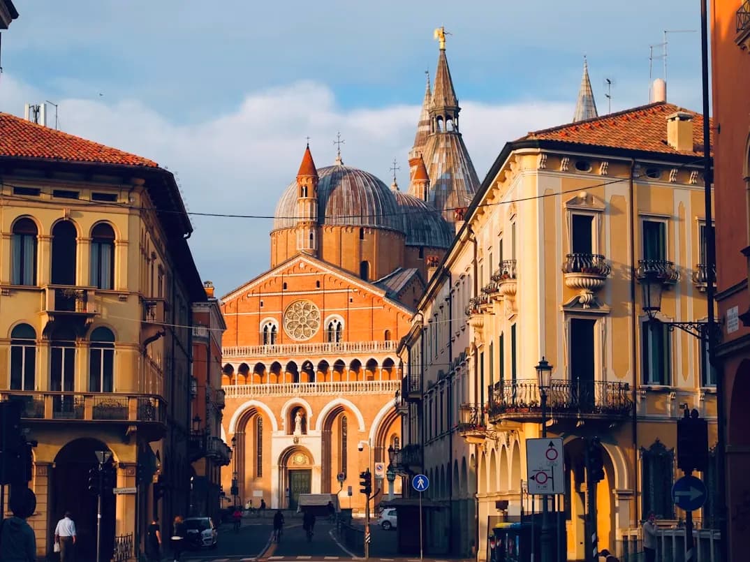 The magnificent Basilica of Saint Anthony of Padua, with its unique domes and spires, is framed by the city's traditional buildings.