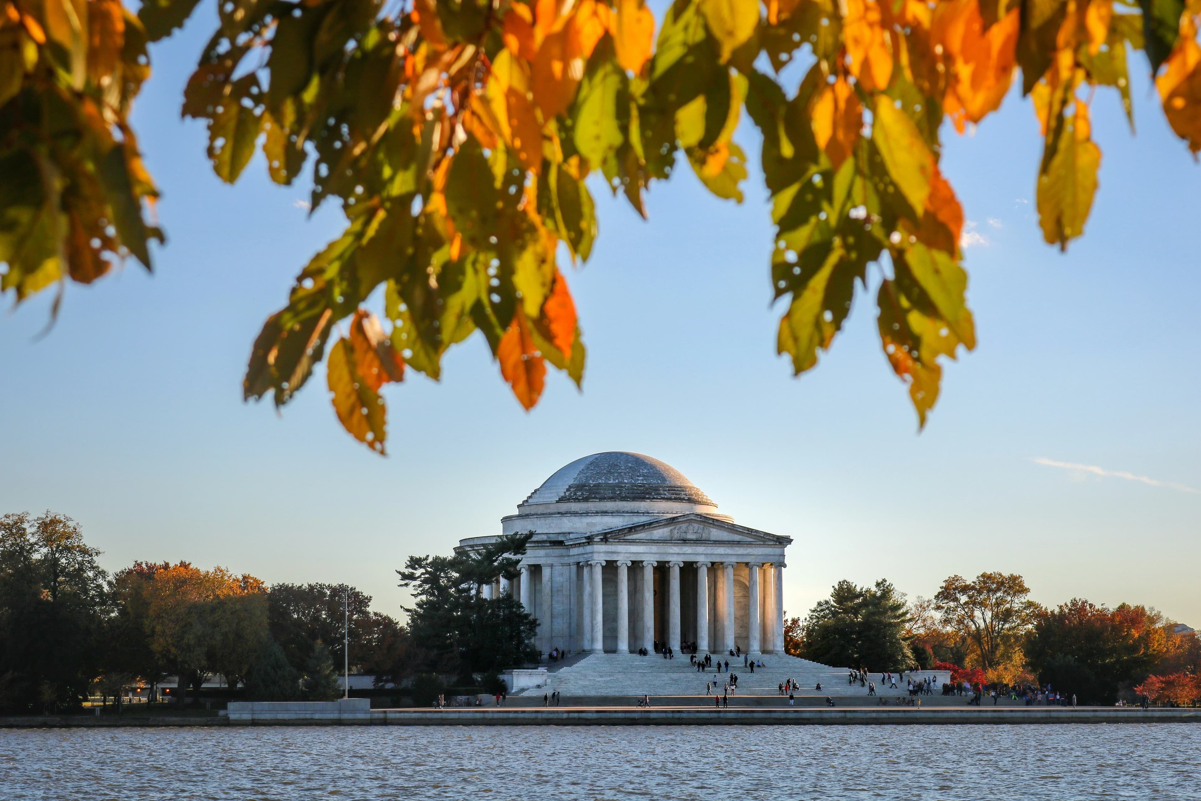 Autumn leaves provide a natural frame for the Jefferson Memorial, which is reflected in the Tidal Basin on a sunny day.